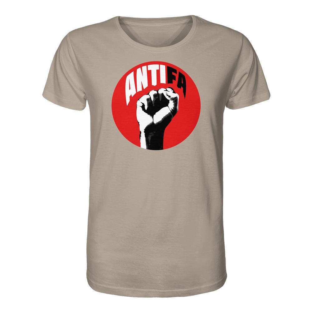 Beige T-Shirt mit rotem Kreis und stilisierter Faust, Aufschrift „ANTIFA“. Bio-Qualität, 100% Baumwolle. Unisex, kämpferisches Design gegen Rechts von RUDE REBEL.