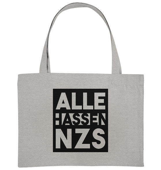 Graue Recycling-Stofftasche mit schwarzem Quadrat und weißem Text ALLE HASSEN NZS!. Nachhaltiges Design von RUDE REBEL, betont Antifaschismus und Umweltfreundlichkeit.