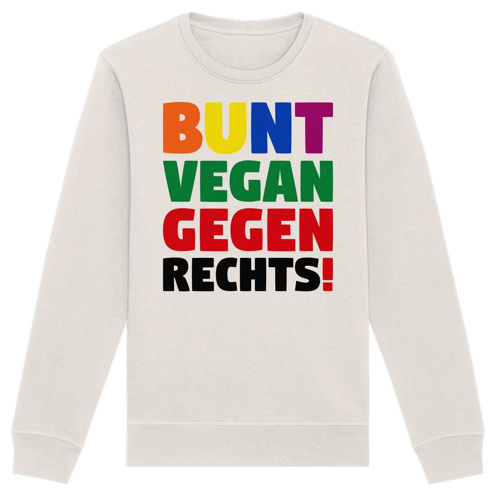 Unisex-Sweatshirt mit dem Slogan BUNT, VEGAN und GEGEN RECHTS! in Regenbogenfarben, grün, rot und schwarz auf cremefarbenem Stoff. Bio-Baumwolle, nachhaltiges Design.