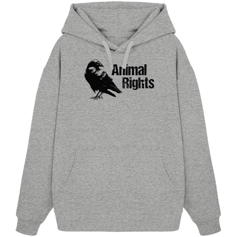 Vegan und Bio Oversized Hoodie: Raven - Animal Rights, ein hellgrauer Kapuzenpullover mit Kängurutasche und stilisiertem Vogelprint, symbolisiert Tierschutz und Freiheit.