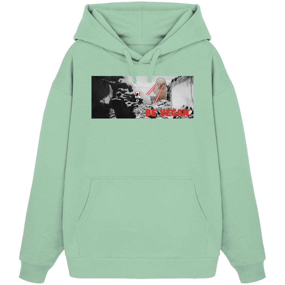 Vegan und Bio Oversized Hoodie: BE VEGAN. Pastellgrüner Hoodie mit apokalyptischem Grafikdruck und rotem Text, aus 100% Bio-Baumwolle.