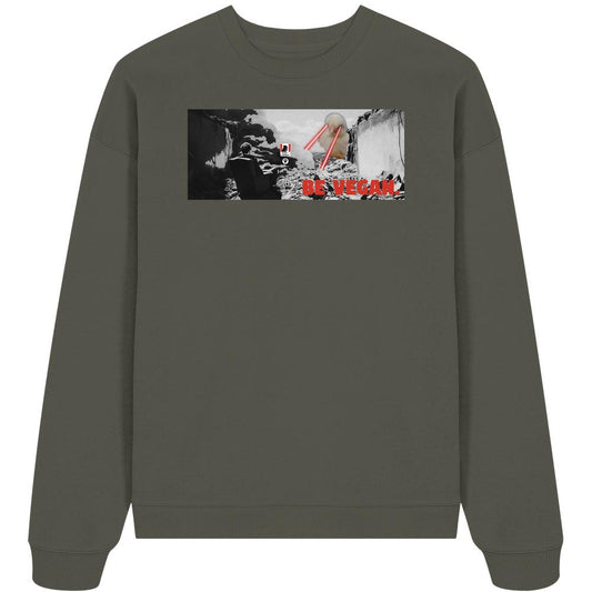 Vegan und Bio Oversized Sweatshirt: BE VEGAN Grafik mit zerstörter Stadt, fliegender Untertasse und Slogan, aus 100% Bio-Baumwolle.