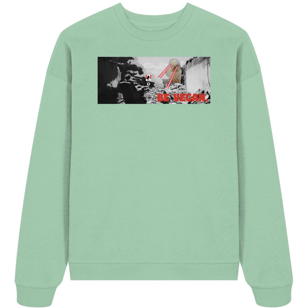 Vegan und Bio Oversized Sweatshirt: BE VEGAN. - Darstellung einer Figur in Ruinen mit roter Aufschrift BE VEGAN., 100% Bio-Baumwolle, oversized Fit.
