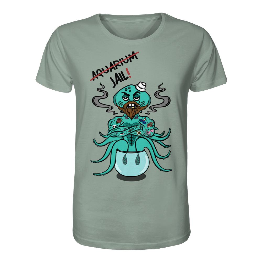 Sagegrünes T-Shirt mit Cartoon-Oktopus im Fischglas, Seemannshut, tätowierten Tentakeln, grimmig; Aufschrift: Aquarium durchgestrichen, ersetzt durch Jail!. Vegan und Bio Unisex Shirt: Animal Rights - Aquarium=Jail!