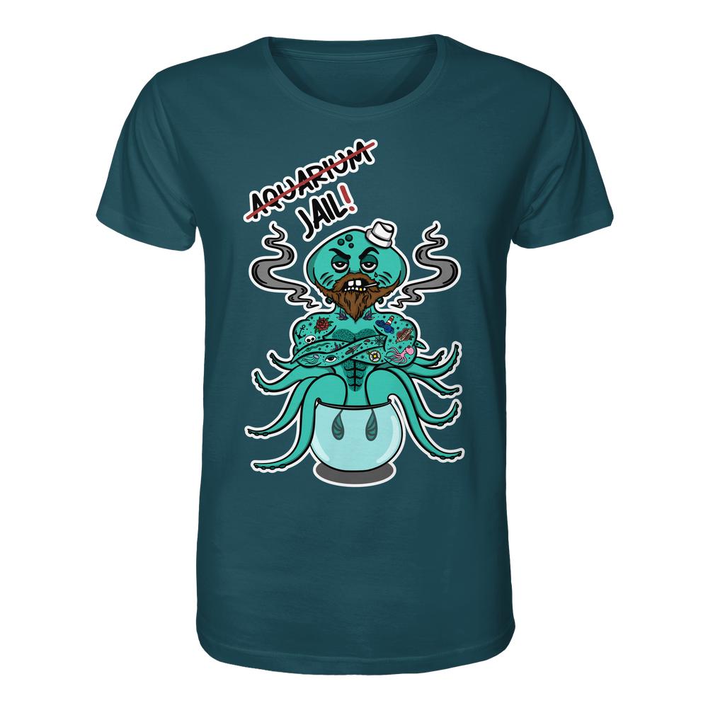 Unisex-Shirt mit Cartoon-Design: Bärtiger Oktopus im Aquarium, Jail! darüber. Veganes Bio-Baumwolle-Material, normale Passform. Thema: Tierrechte, rebellisches Design von RUDE REBEL.